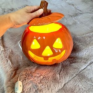 Ceramic jack-o-lantern lamp.